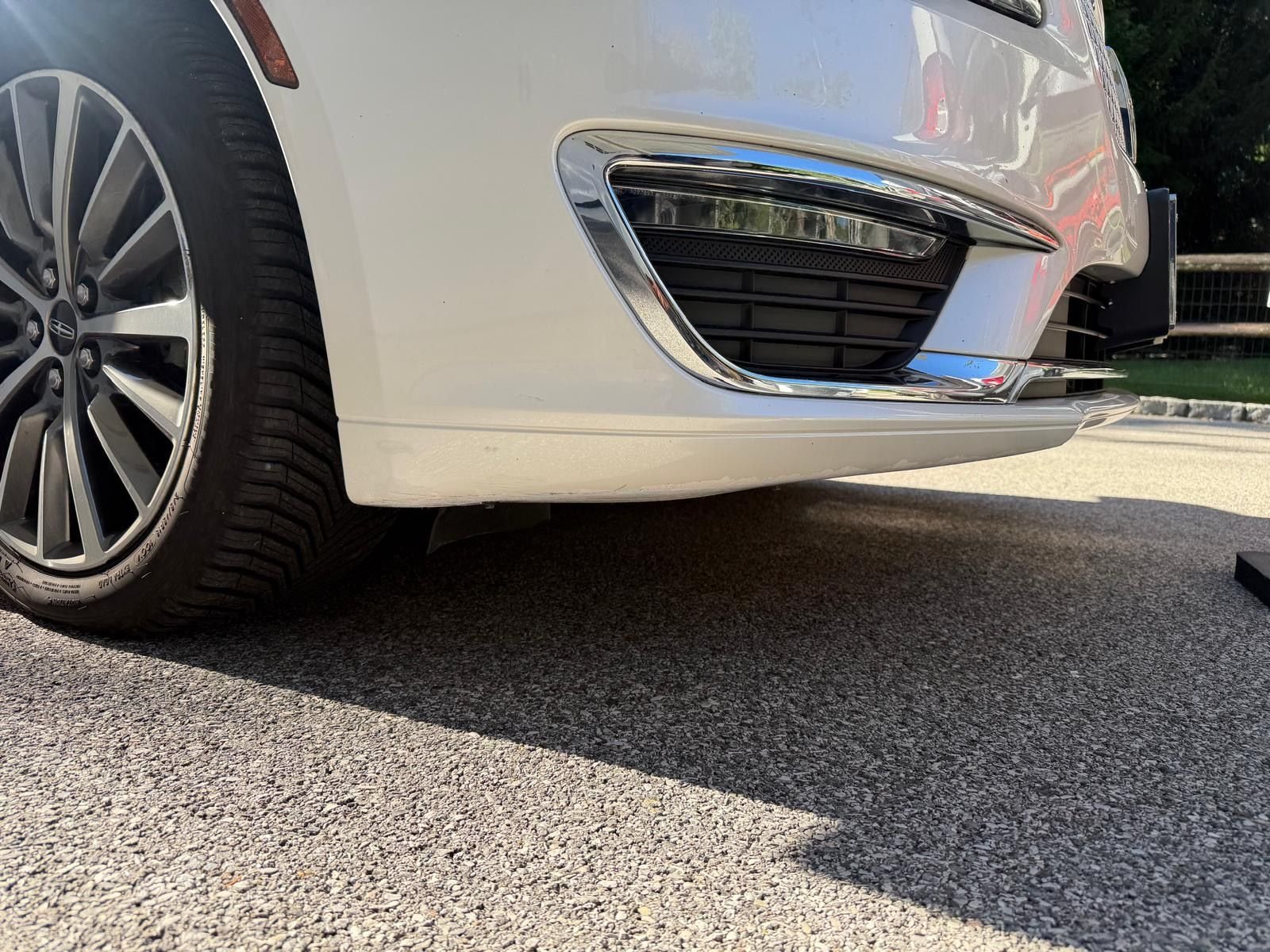 White Lincoln MKS front bumper after cosmetic repair