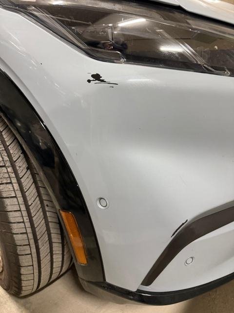 Paint chip and scuff on a gray Mustang Mach-E fender